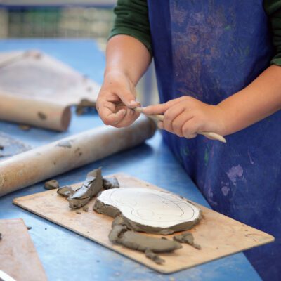 Hands of a child working with clay