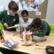 Children building a dormouse nesting box