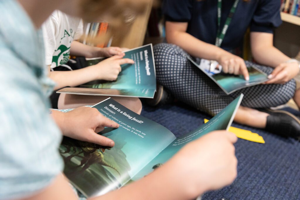 close up of children reading a shared text