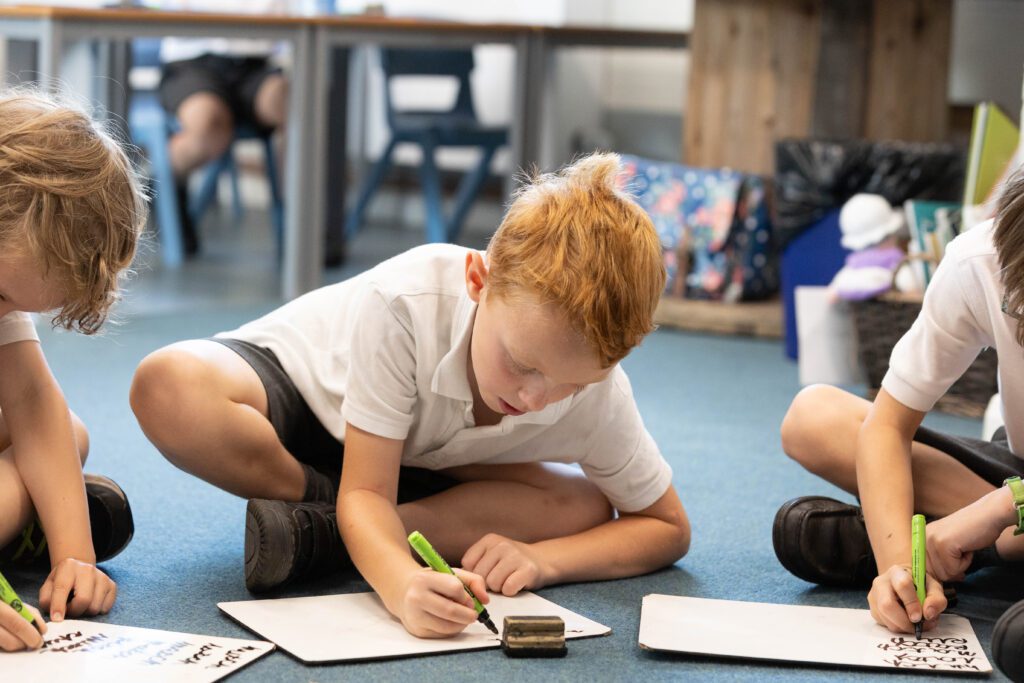 child writing on a whiteboard