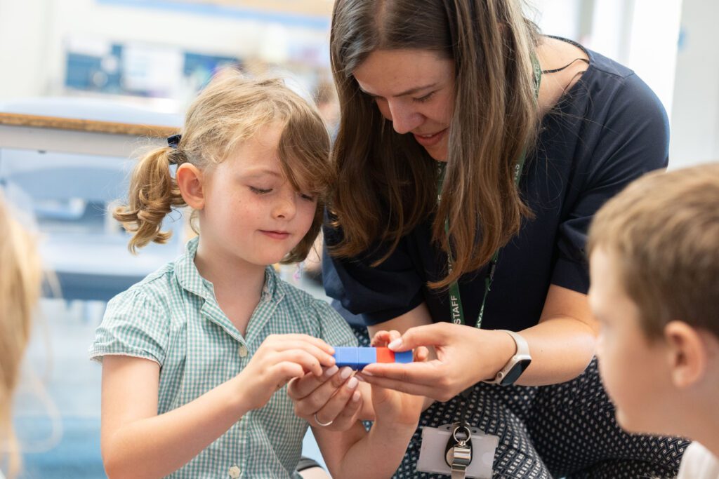 teacher teaching phonics to a child